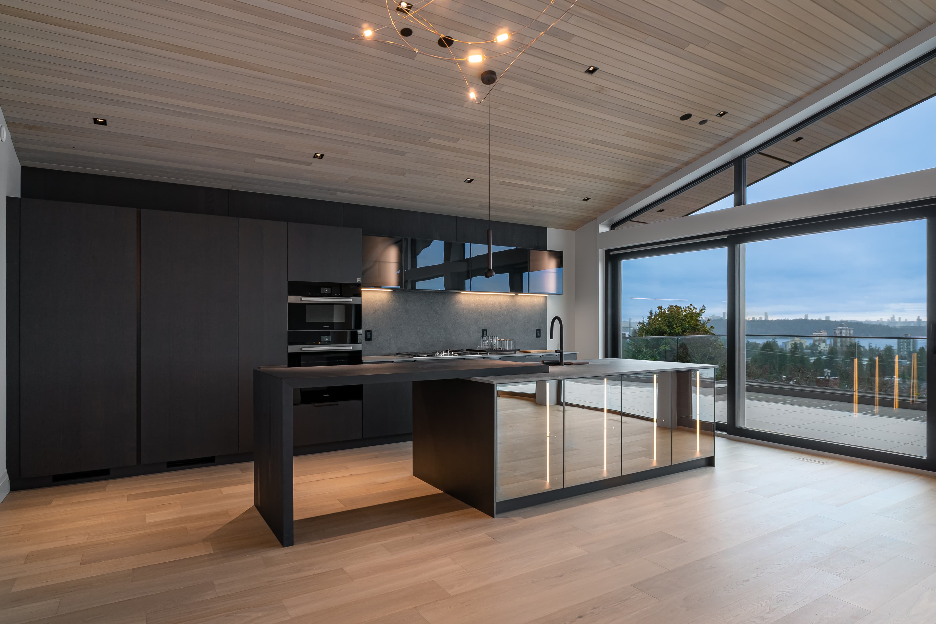 Nelson House 3 — twilight kitchen with floor-to-ceiling windows